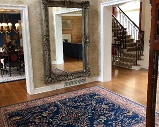 Beautiful  blue field Oriental rug and oversize silver leaf mirror