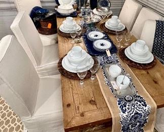 Antique French farmhouse table, set of 6 Mitchell Gold parsons chairs w/linen covers, large area rug, Crate & Barrel china, wine and water goblets, table runner, decorative blue & white china 