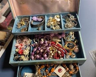 Vintage and some antique costume jewelry in box. 