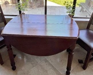 Antique drop leaf table. Sturdy chairs.