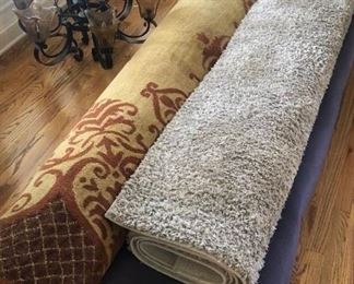 Two of several room-sized rugs for sale