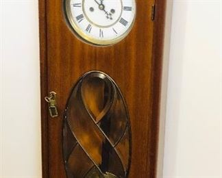 Antique wall clock with leaded glass in door (35.5”H, 13”W, 5”D)