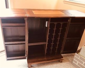 Bar when open - doors open wide & hinged top flips out from center. Has storage for 21 bottles of wine + storage on doors & shelves (as shown 60”L, 18”D, 41”H)
