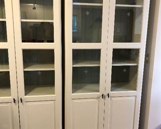 IKEA Liatorp bookcase with glass doors. We have 3 alike that fit together to form a wall unit. Interior shelves are adjustable.  (Overall dimensions: 108.5”L, 84.5”H, 14.5”D)
