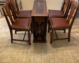 Drop leaf table with (4) chairs.                        59” L 35.5”w 29” t.                                                    $250.00