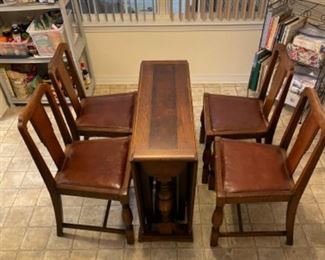 Drop leaf table with (4) chairs.                        59” L 35.5”w 29” t.                                                    $250.00
