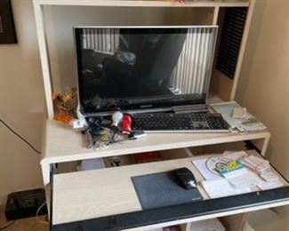 Cream color rolling computer desk.              35.5”w 19.75” d 53”t.                                            $35.00