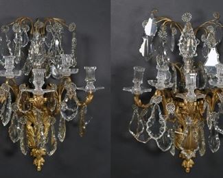 23	Pair Baccarat Style Gilt Bronze & Crystal Sconces	Pair of Louis XV style gilt bronze sconces. Baccarat style crystal drops and candle cups. Unsigned. Each 26 1/2"L. Some mismatched crystals. From the collection of a prominent Connecticut family.
