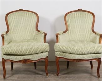 34	Pair of Louis XV Style Bergere Armchairs	"Pair of Louis XV style bergeres (closed armchairs). 19th century. Carved walnut, cabriole legs, later upholstery and cushions. Relining to underside of chairs. Wear, nicks, chips, and marks throughout wood of both chairs. Small separations to wood on carved top rails of both chairs. Chip to wood on left arm of one chairs. Wear and light fraying to upholstery. Chips to wood on edges of carving on apron of one chair. 

26"" W x 27"" D x 37 1/4"" H.

From the collection of a prominent Connecticut family."
