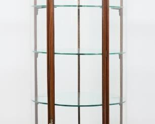 41	19th Century English Rounded Vitrine	"English rounded vitrine or curio cabinet. 19th century. Walnut frame, urn final, three glass shelves. Original key is included. Brass ring door pulls stamped ""PATENT 3558 E. POLLARD & CO. LONDON."" Chip and fleabite to glass on edges of top and bottom shelf respectively. Scratches and scuffs throughout glass shelves. Split to wood on one bent wood post on dome. Splits to wood on joinery of legs to apron of vitrine. Nicks and chips to wood on feet and edges of apron. From the collection of a prominent Connecticut family.
87"" H x 29 1/2"" diameter"
