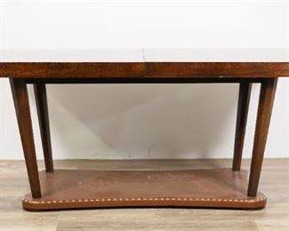 42	Gilbert Rohde for Herman Miller Paldao Group Table	"Gilbert Rohde (New York, 1894-1944). Art Deco dining table of the Paldao Group by Herman Miller. Zeeland. Michigan, circa 1940. Brazilian paldao wood, top with incised curving design, sculptural legs, faux leather base with nailhead trim. Two leaves with original holder, glass covers for table and leaves, and  leather table covers are included. ""4190"" stamped into underside of top. Herman Miller labels on underside of top and on leaf holders. Water damage, scuffs, marks and losses to wood throughout top of table. Scuffs, wear, scratches, and stains to glass covers. Chips to corners of glass leaf covers. Scuffs and scratches to wood on edges of top. Nicks, scratches, scuffs, and losses to veneer and wood of both leaves. Tattering, scratches, and dirt to faux leather of table base. Nicks and scratches to wood of table legs. Wear throughout surface of leaf holder. Wear, cracking, warping and mold to table covers. 

67 7/8"" W x 40""