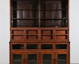 44	W.B. McLean Commercial Tobacco Cabinet	"Commercial tobacco cabinet from the ""Good Fixtures"" line of the W.B. McLean Manufacturing Company. Pittsburgh, PA, 1921-1922. Mahogany, top cabinet with four shelves, two later sliding glass doors, and two storage areas each covered by two notch doors. Top of cabinet crowned with original ""CIGAR"" sign. A second piece of blank glass for sign is provided with the cabinet. Bottom half of cabinet with metal lined interior, four compartments each with spring hinge glass doors, four compartments below with slatted shelves each with glass doors with metal pulls. ""Good Fixtures"" W.B. McLean label on center of top and bottom portion of cabinet. Top and bottom half numbered and dated ""No. 1396"" ""1922"" and No. 1206"" ""1921"" respectively. Wear and light scratches to glass doors throughout piece. Scratches, marks and scuffs to wood of front of top cabinet. Chips to wood on lower molding below glass doors and to top of bottom half of cabinet. Ho