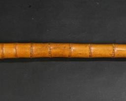 49	Bamboo Gun Cane	19th Century bamboo walking stick with concealed dagger pepperbox pistol. Bamboo walking stick with metal tip. Handle top carved with bone inlay. 4 shot percussion pepperbox pistol. Trigger in working order. Metal at bottom of the cane is rusted and pitted. No visible makers marks. 34 1/4" tall. From the collection of a prominent Connecticut family.
