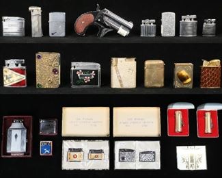 48	Lot of Lighters & Match Safes	21 lighters including Zippo, Firebird, 3 Ronson Adonis - 1 with original felt pouch, Ronson Standard, Ronson Varaflame, Evans snakeskin, Park, Judy Baby Baby Style, Willow New Style, Star-Lite Automatic, Continental, Corona gun, Ronson Mastercase with original box and pouch, 2 Ronson Ladylite with original boxes, Royal Star 2 99 Series 2 lighter set in original box, The World's Thinnest 2 lighter set in original box; gold tone match safe and 2 match holders, Elgin American cigarette case. Lighters all untested.
