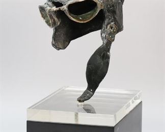 82	John Nelson Battenberg Sculpture Helmet	John Nelson Battenberg (American, 1931-2012). Aviator's helmet, patinated bronze sculpture on plexiglass and wooden base. Signed and dated on the chin strap. With receipt from Krasner Gallery, Madison Avenue, New York, dated 1969. Sculpture 13"H, with base 18"H x 7 1/2"L x 9 3/4"W. Minor wear and losses to patina, scratches to lucite on base.

