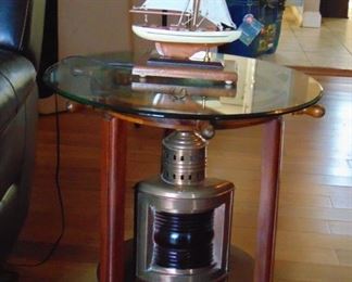 2 of 2 (sold as a set) 23" glass top end tables with ship's wheel-base, and brass navigational light (table-top lamp sold separately)
