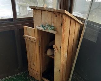 Cute little pretend outdoor toilet with cabbage patch doll