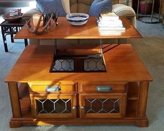 The oak coffee table with the top lifted