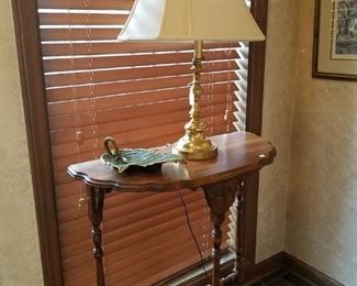 Brass lamp on a three-legged table