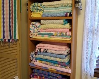 This cabinet is full of new handmade baby/small child afghans