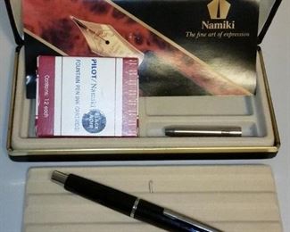 Namiki (Parker) 'Vanishing Point' fountain pen with extra part and ink cartridges.  The nib is 14KT white gold.