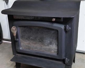 Small wood burning stove with glass door