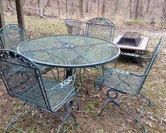 Wrought iron round table and four rocking patio chair