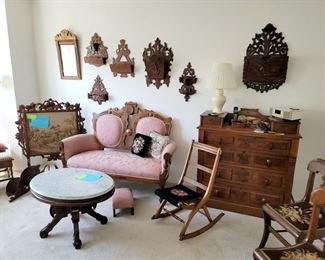 Eastlake fireplace screen, settee, marble top coffee table, folding rocker, chest of 4 drawers with glove boxes.  Carved wood wall pockets.