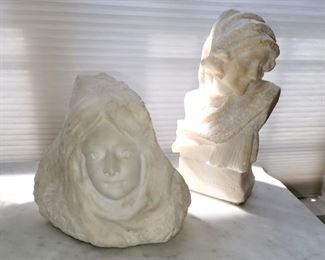 carved stone female busts