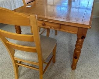 Dining room table with leaf and 4 padded chairs.