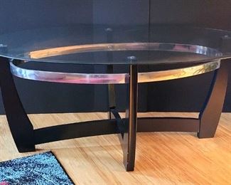 Oval Glass Coffee Table with Curved Legs and a Chrome Trim