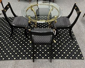 HEAVY SOLID SWAN TABLE WITH SET OF BLACK AND GOLD HOLLYWOOD CHAIRS. NEW FABRIC ON SEATS.
