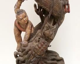 1004	CARVED WOOD ASIAN SERPENT SURROUNDED BY PEOPLE, APPROXIMATELY 21 IN HIGH
