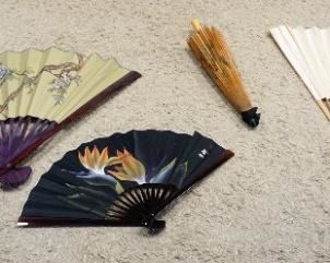 1282	GROUP OF LARGE ASIAN WALL FANS & PARASOL, LARGEST APPROXIMATELY 40 IN X 48 IN OPEN
