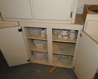 White plates, and dishes, along with ramekins. Cabinets are also for sale