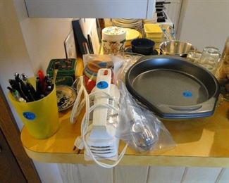 The kitchen holds a lot of pots and pans and much needed cooking supplies as well