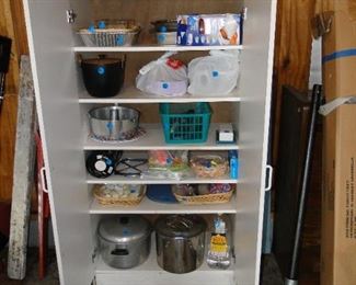 Cabinet with kitchen supplies, and paper products, cabinet is also for sale too