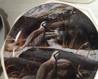 Wild fowl go about their business on this porcelain collector plate. 