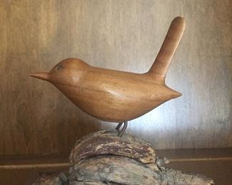 Notice the wood grain on this bird standing on a pod-like piece. 