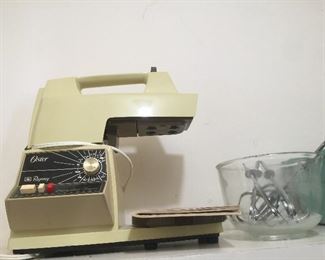 An Oster power base that supports a mixer, blender and food processor. 