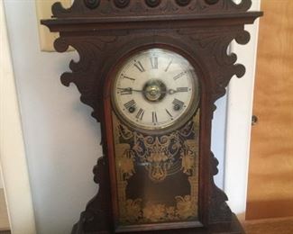 A handsome mantle clock with pendulum and key. 