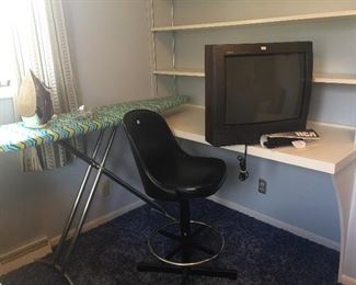 Work and fun are found with a sturdy ironing board, Rowenta iron, a swivel stool and old-school RCA television with remote. 