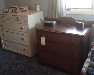 The white dresser features a Formica-like top with gold specks while the three-drawer dresser offers a more traditional option. 