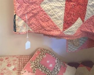 Pretty pastels star in these hand-stitched quilts. The exception is the newer quilt on the left. 