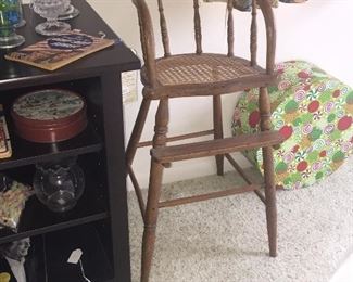 A bent-oak youth chair with caned seat offers a delightful place for a child to sit or to display a beloved doll or teddy. 
