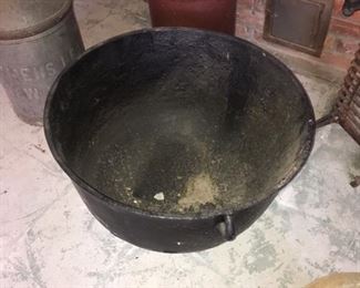 A large cast iron cauldron big enough to hold toys or flowers. 