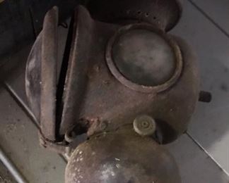 A weighty light that likely was salvaged from an old automobile. 