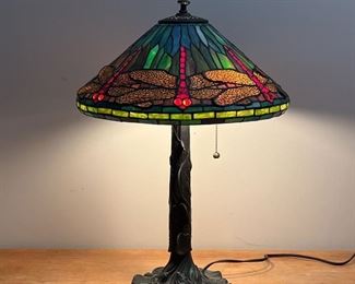 TIFFANY-STYLE DRAGONFLY LAMP |  Tiffany-style stained glass lamp, dragonflies with "jewel" bead eyes, on a cast metal base with viney lily pads, two lights with pulls
Dimensions: h. 24 x dia. 17 in.