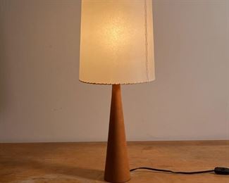 MODERN TABLE LAMP | Tapering wood table lamp of modern design with a stitched leather-type shade, semi-translucent
Dimensions: h. 24 x dia. 9-1/2 in.