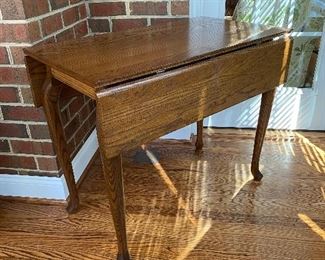 (F26) $125. Small solid wood drop leaf table. 